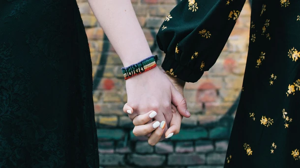 Two moms holding hands