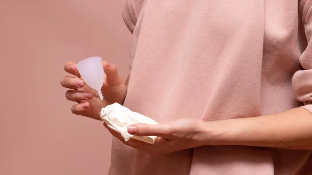 Woman holding a menstrual cup