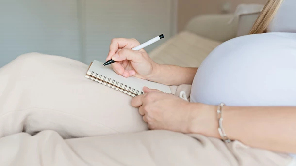Pregnant woman writing list