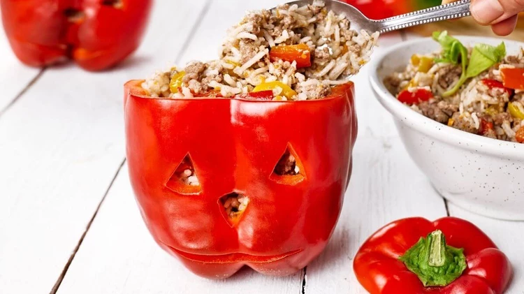 Jack-o-lantern stuffed peppers - Halloween Food Ideas for Kids