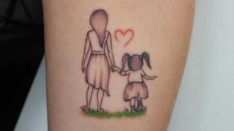 mother holding child tattoo