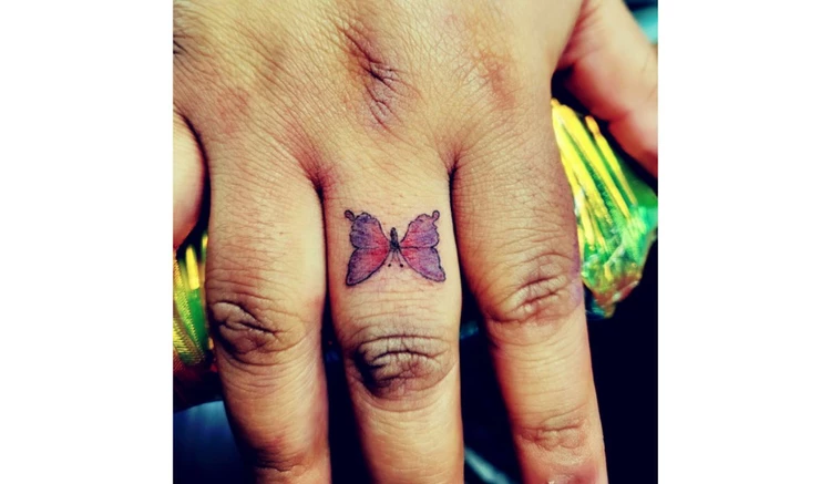 Butterfly finger tattoo