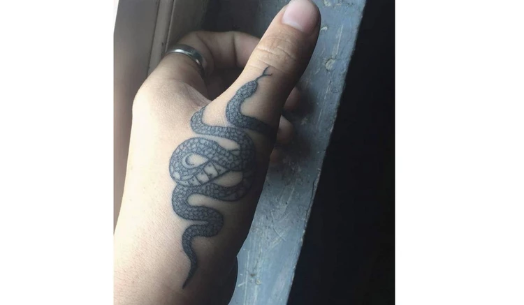 Snake finger tattoo