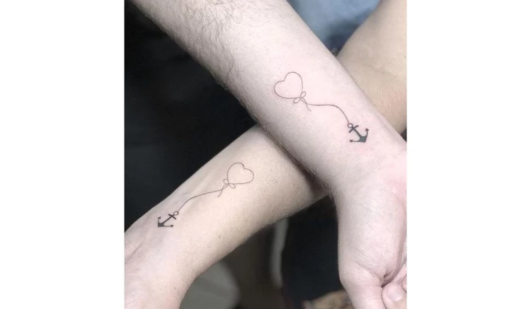 Matching anchors mother son tattoo