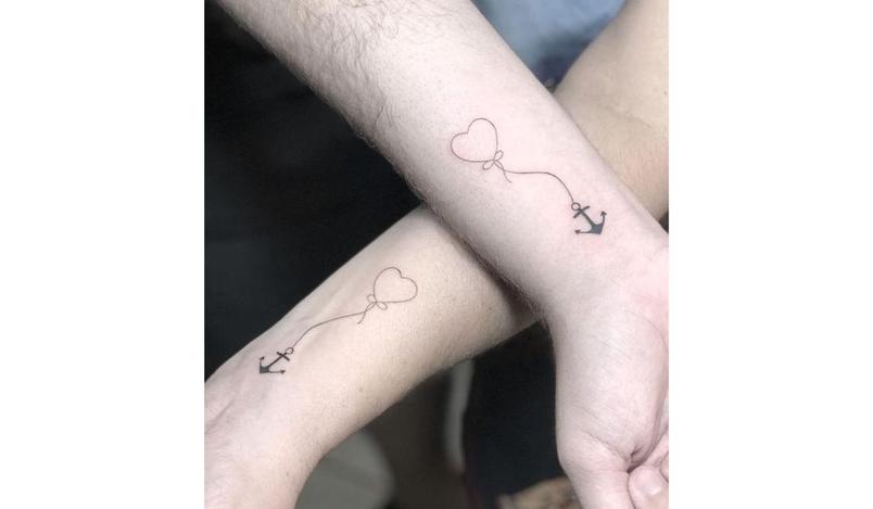 Matching anchors mother son tattoo